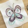 porte-clés papillon oeil en tissu brodé et imaginé par Anne Da Cunha-Guillegault en exclusivité pour la marque An'imato